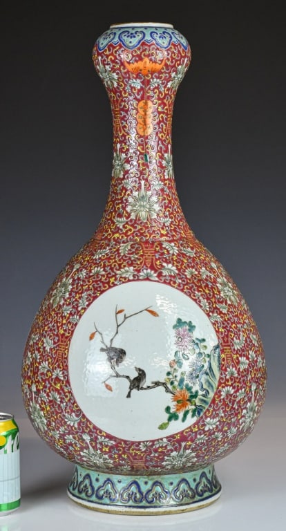 A Large Famille Rose Garlic-Head Vase 19thC: The pear-shaped body supported on a short foot, tapering to a tall neck with a garlic-head mouth and upright rim, the exterior painted with floral scrolls, coin motifs, bats and birds amid 