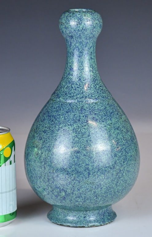 A Robin-Egg Glazed Garlic-Head Vase, Qing: Potted with a pear-shaped body below a raised rib at the shoulder, rising to a slender neck and bulb-shaped mouth, covered overall with a thick turquoise and lavender-blue glaze, H:28cm 清 Ĥ
