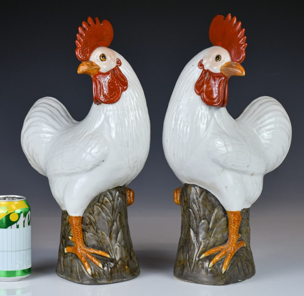 A Pair of Porcelain Roosters Republican: A pair of porcelain rooster figures, modelled standing on stump bases and decorated in coloured glazes. H: 40cm 民國 彫瓷公雞對