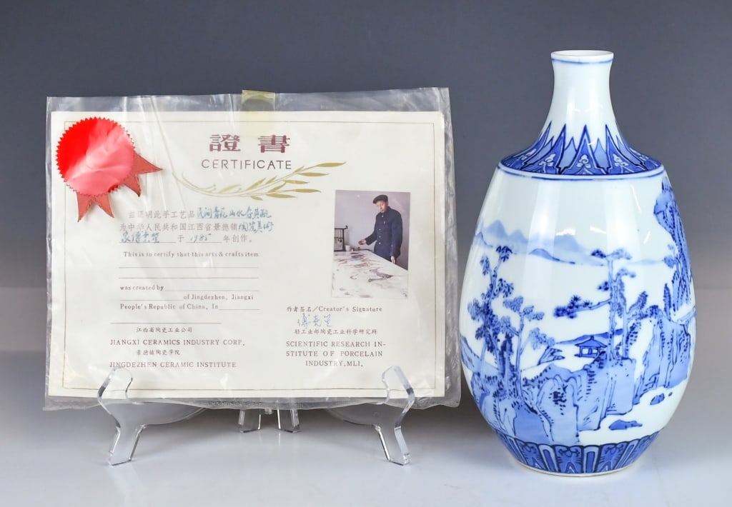 Fu YaoSheng (1936-2003) Blue & White Yuhuchun Vase: the pear-shaped body elegantly painted in varying tones of underglaze blue, with a continuous scene of a serene mountain landscape. Four-character JingDe mark at the base. H:23cmProvenance: