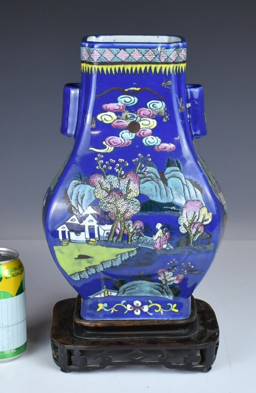 A Blue Ground Landscape Vase Kangxi Mk w/Std 19thC: Of baluster form, set against a deep blue ground and decorated within a shaped reserve with figures in a mountainous landscape, the shoulder applied with handles, the rim and foot with geometric