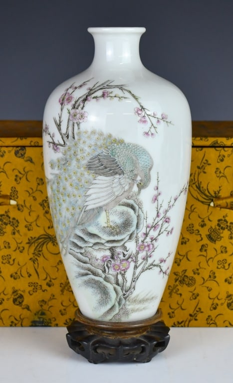 A Famille Rose Vase Juren Tang Mk w/Std Repulican: Of ovoid form rising to a waisted neck, painted with a peacock standing on rockwork beneath prunus blossoms, four-character Juren Tang mark at the bottom, comes with a wood stand. H: 22.1cm 