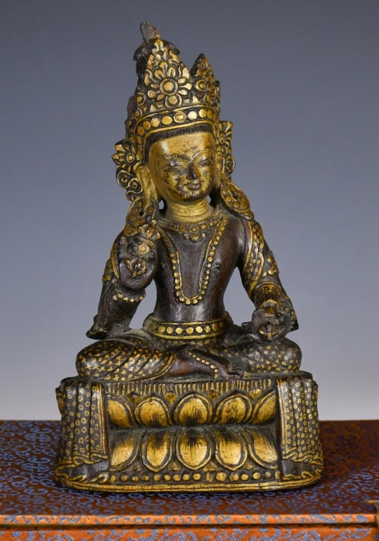 A Gilt-Wood Figure of Vajrasattva w/Box 18thC: Seated on a loti form base, sitting cross-legged in padmasana, with the right hand in Kataka mudra and the left hand gently resting on the left thigh in Kataka mudra. H: 16.3cm 18世紀