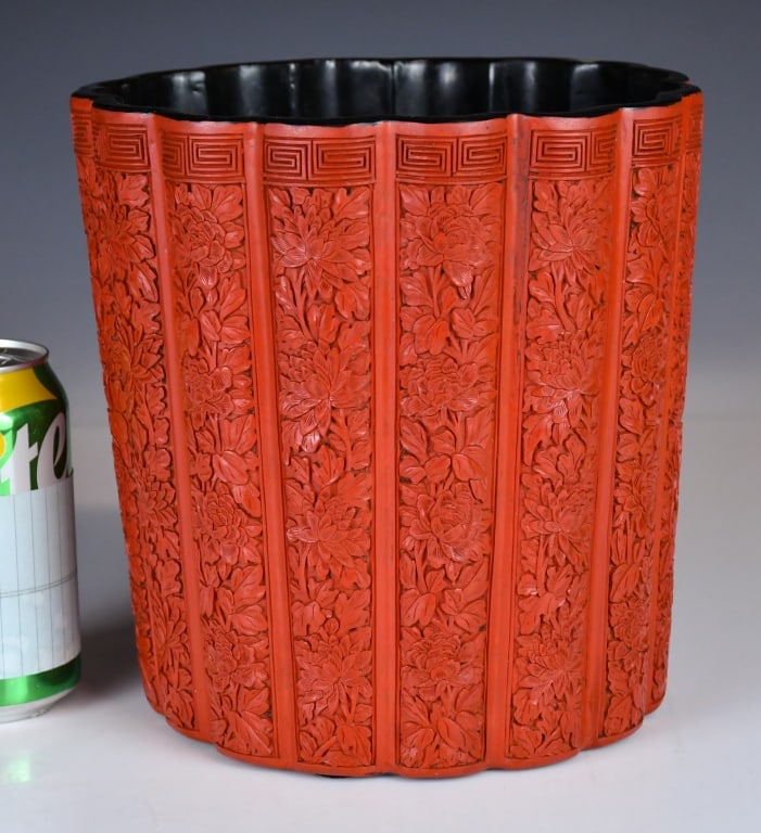 Lrg Carved Cinnabar Lacquer Floral Brush Pot Qing: Of a cylindrical form with a subtly lobed rim and body, supported on a flat base. The exterior is meticulously carved through thick layers of rich, deep red lacquer to a black ground, displaying 