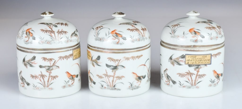 3 Set Grisaille & Iron-red Gilt Wine Warmers 19thC: Each is elegantly potted and comprises three distinct parts: a cylindrical outer warming vessel, a conforming inner wine cup, and a domed cover surmounted by a delicate bud-form finial. H:10.5cm each