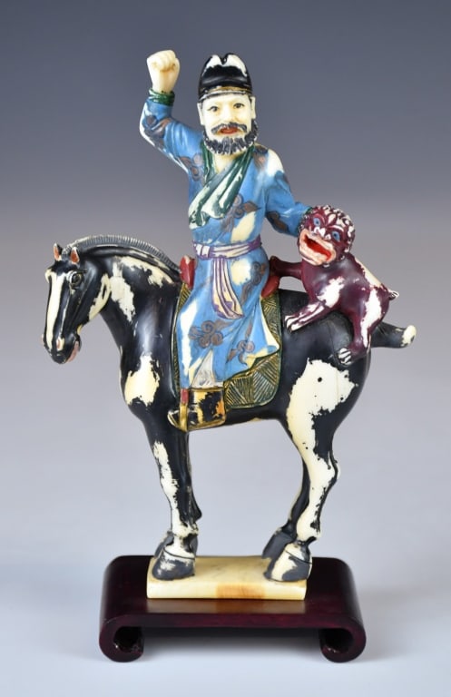 A Bone-Carved Statue w/Std Republican: A bone-carved statue of a man and a beast riding on a horse, with colour painted on. H: 15cm 民國 加彩骨雕擺件 連座 Click here for