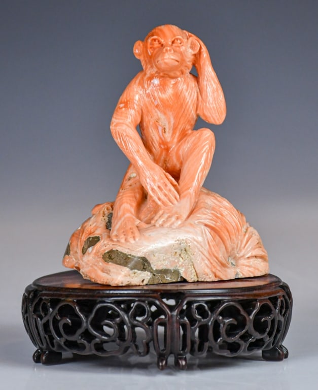 A Coral Carved Monkey Sculpture w/Std 20thC: A finely carved coral depicting a monkey seated on a rock, scratching its head, comes with a stand. H:11cm 20世紀 珊瑚雕猴擺件 連座 