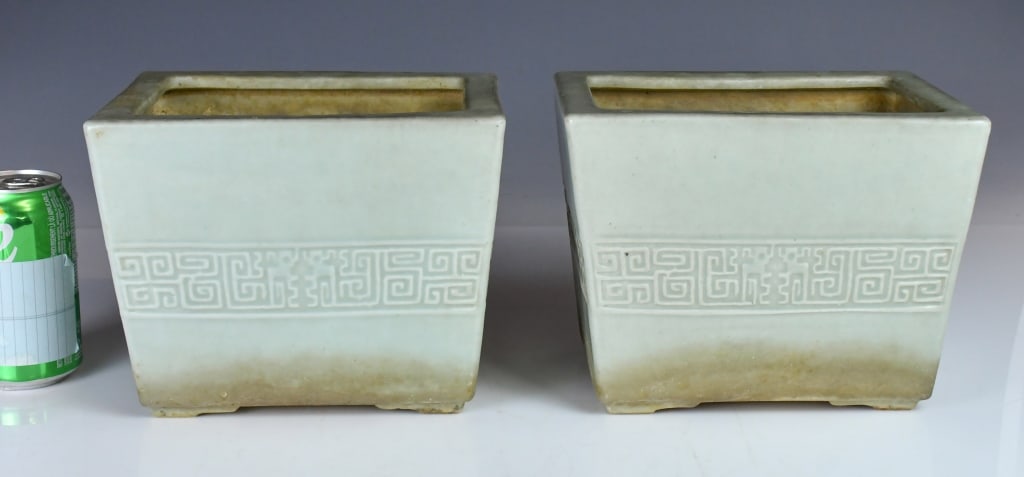 A Pair of Celadon Glazed Planters 19thC: A pair of rectangular planters, the exterior surfaces decorated with carved patterns. H: 17.6cm (x2) 19世紀 青釉花盆一對 Click here for natural