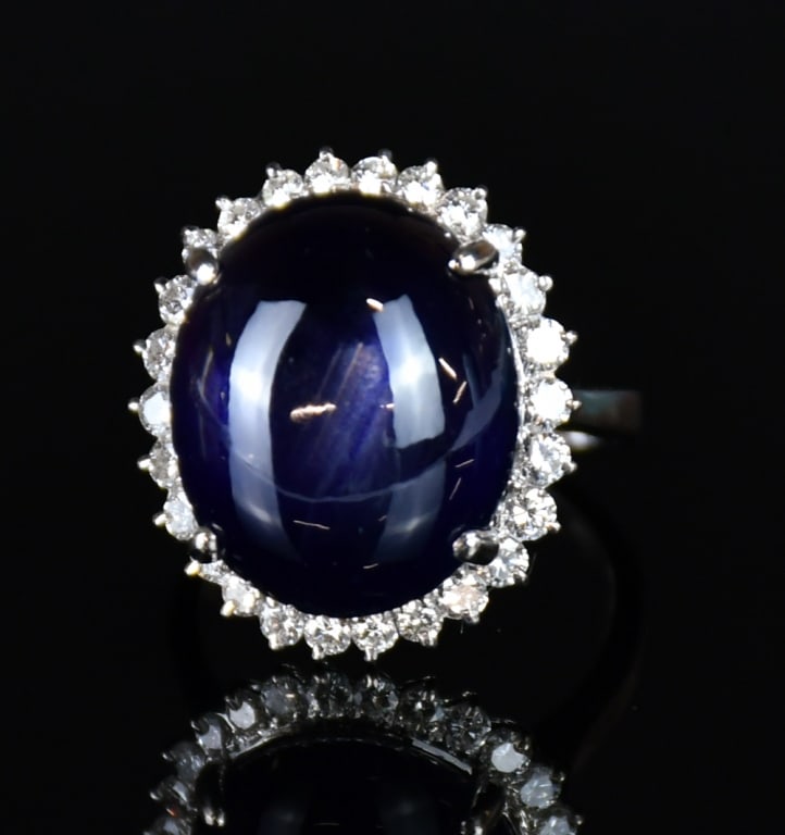 A Platinum Star Sapphire & Diamond Ring: Centering a cabochon star sapphire surrounded by diamonds, mounted in platinum. Comes with certificate. NOTE: ONLY WIRE TRANSFER PAYMENT ACCEPTED FOR THIS LOT. All sales proceeds will donate to