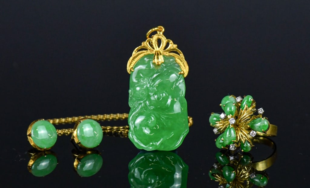 A Group of 4 Jadeite & 14K Gold Jewellery Pieces: Comprising a jadeite pendant (4.6x2.4cm) mounted in 14K gold, a pair of jadeite earrings, and a jadeite ring (size 6), all set in 14K gold, the mounts stamped "585". 