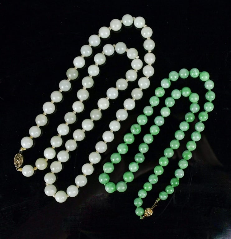 A Group of 2 Jade and Jadeite Necklaces: Comprising a necklace of white jade beads and a necklace of jadeite beads, the jadeite necklace with a 14K gold clasp stamped "14K" Longer L: 34.5cmnt 