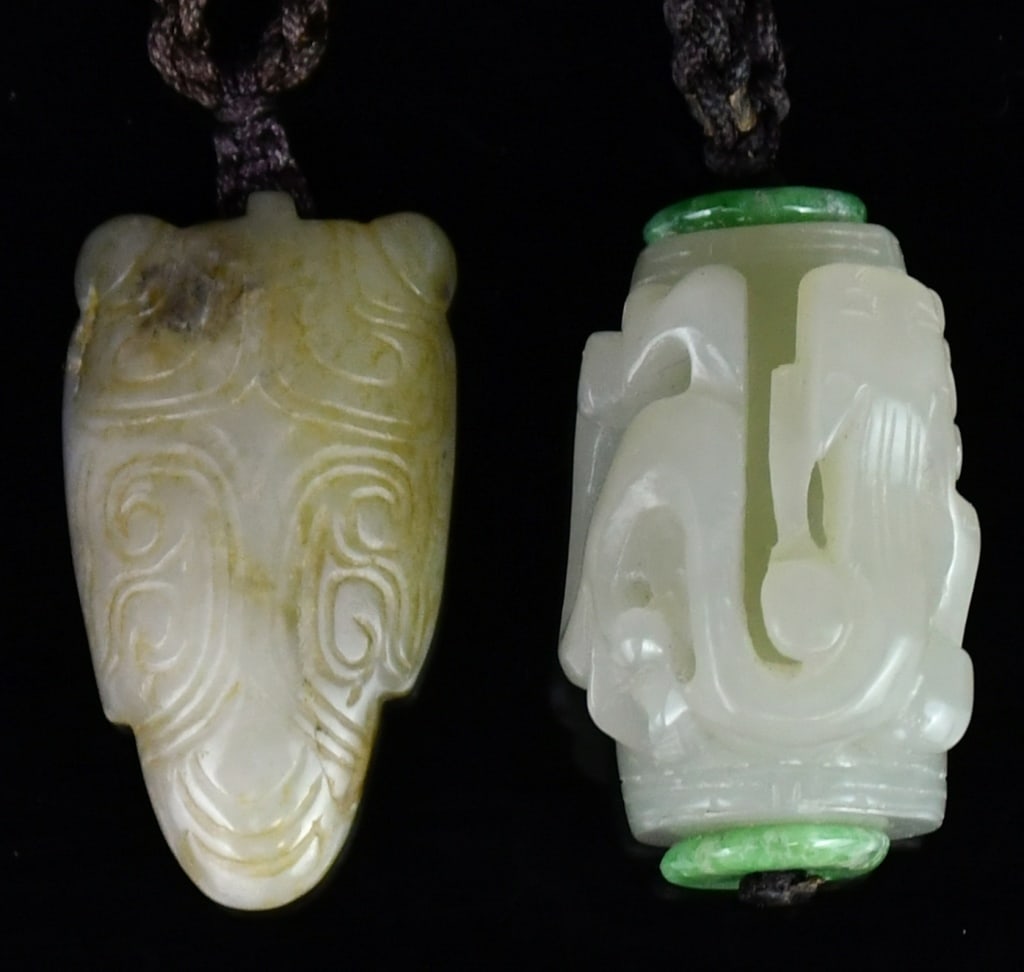A Group of 2 Jade Pendants Qing: Comprising two jade carvings, the first of cylindrical form carved in relief with a chilong, the stone of celadon tone, 3.3x2.2cm; the second carved with motifs, the stone of yellowish celadon 