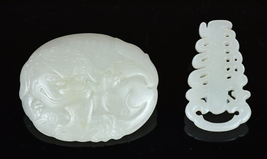 A Group of 2 White Jade Belt Hooks Republican: Comprising one oval plaque finely carved in shallow relief with a beast, the reverse with two raised bosses, 6.9x5.3cm; together with an openwork plaque, 5.5x3.1; both worked from light 