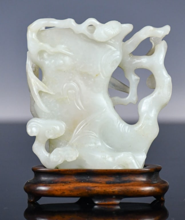 A White Jade Carved Bamboo Shape Vase Republican: In the shape of a bamboo, the side is wrapped with younger bamboo, the stone overall in pale celadon tone, 6x4.4cm 民國 白玉雕竹節花插