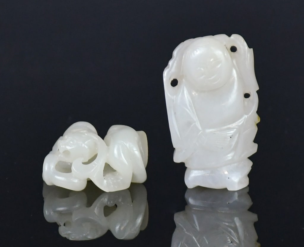 A Group of 2 Jade Carvings Qing: Comprising two jade carvings, including a standing figure and an openwork mythical beast, both of overall white tone. Larger H: 4.2cm 清