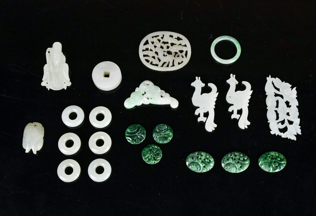 Group of 21 Jade Carvings & Ornaments: Comprising a group of 21 jade carvings and ornaments of various forms and sizes, including circular rings, openwork plaques, small figural and animal carvings, and decorative elements. Largest L: