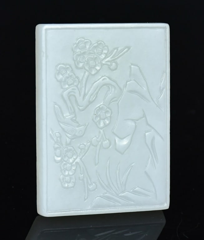 A White Jade Carved Belt Hook Qing: Of rectangular form, one side worked in low relief with rockwork and flowering blooms, with two button-form elements on the underside. 5.8x4.3cm 清