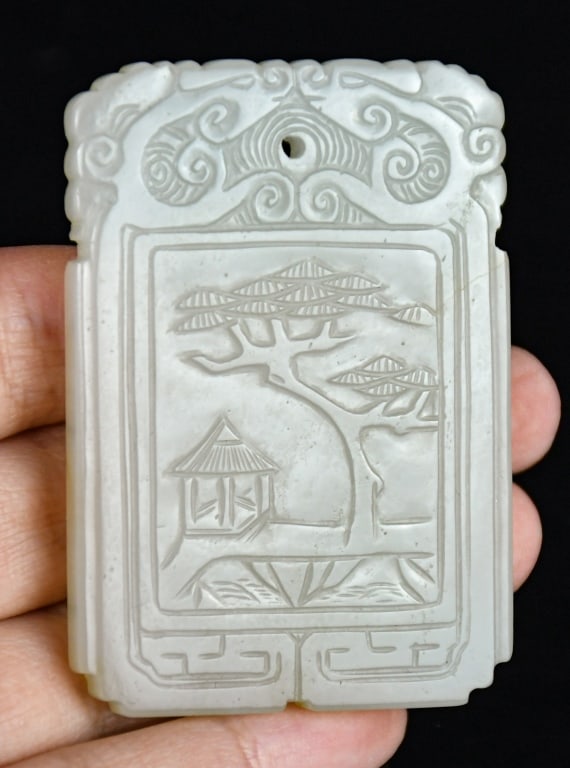 A White Jade Incised Plaque Qing: Of rectangular form, one side carved with a courtyard scene, the reverse incised with Chinese poem; overall in white tone. 5.8x4cm 清