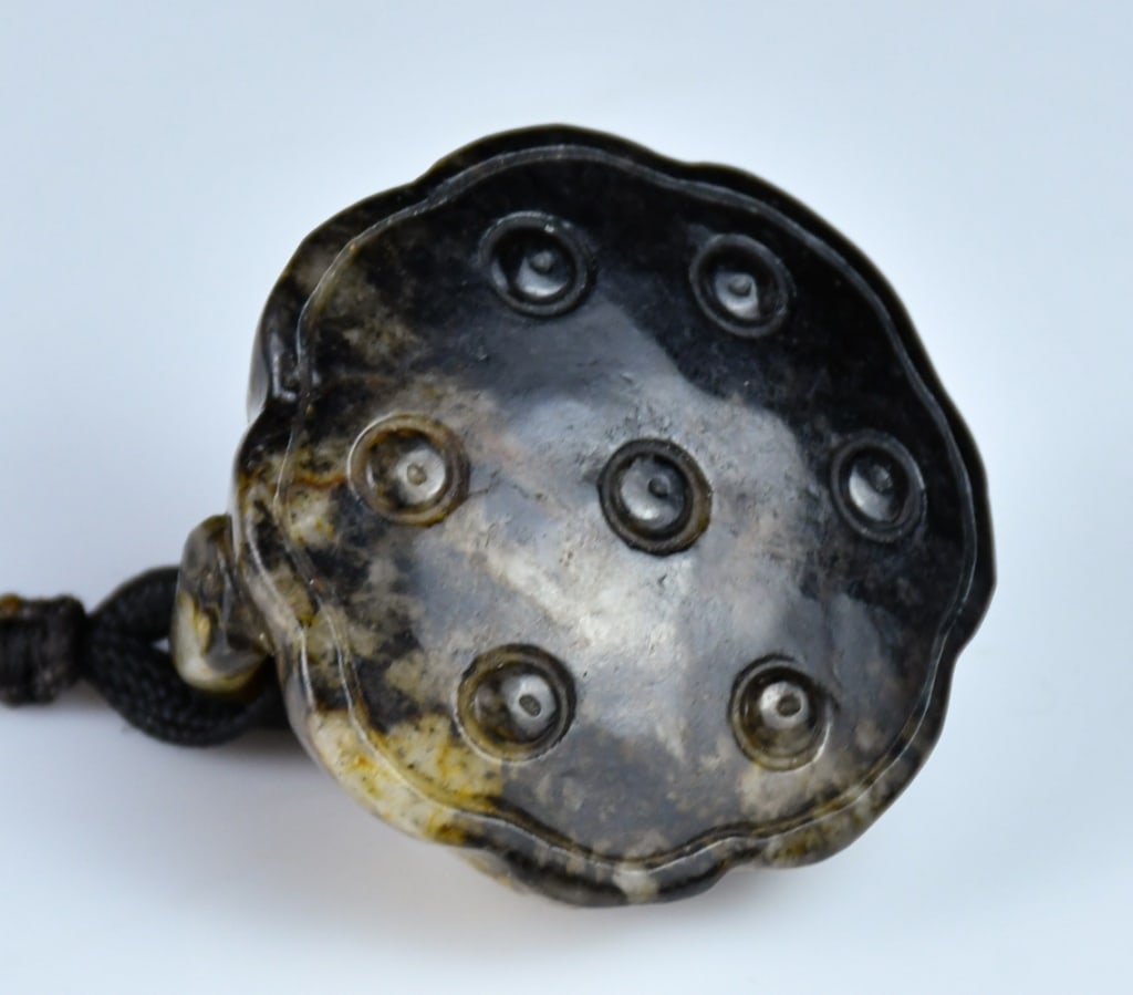 A Jade Carved Lotus Pod Qing: A jade carved lotus pod with a rat on it, the stone overall in dark brown and beige color tone, D:4.3cm 清 玉石雕蓮蓬把件 Click here for