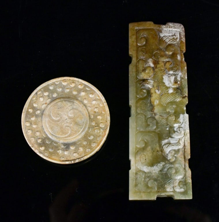 Group of 2 Archaistic Jade Carvings w/Box: Comprising two jade ornaments. The first of rectangular form, carved in low relief with scrolling archaistic motifs. The second of circular form, carved with raised pattern around a central medallion.