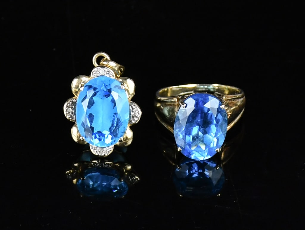 Set of Yellow Gold BlueTopaz Pendant & Ring: One stamped 14K yellow gold casted blue topaz and diamond pendant contains 1 oval shaped cut prong set Blue Topaz and 4 single cut bead set natural diamonds; and one stamped 10K yellow gold casted