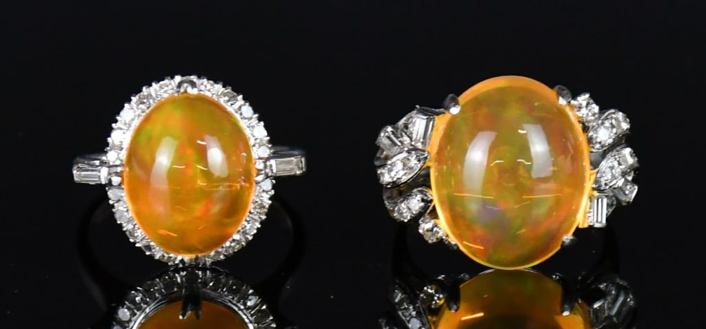 2Pcs 18K White Gold Casted Opal & Diamond Rings: Comprising 2 stamped 18K white gold casted opal and diamond rings: one contains 1 oval cabochon cut prong set fire opal with 22 single cut prona set natural diamonds and 2 baguette cut channel set nat