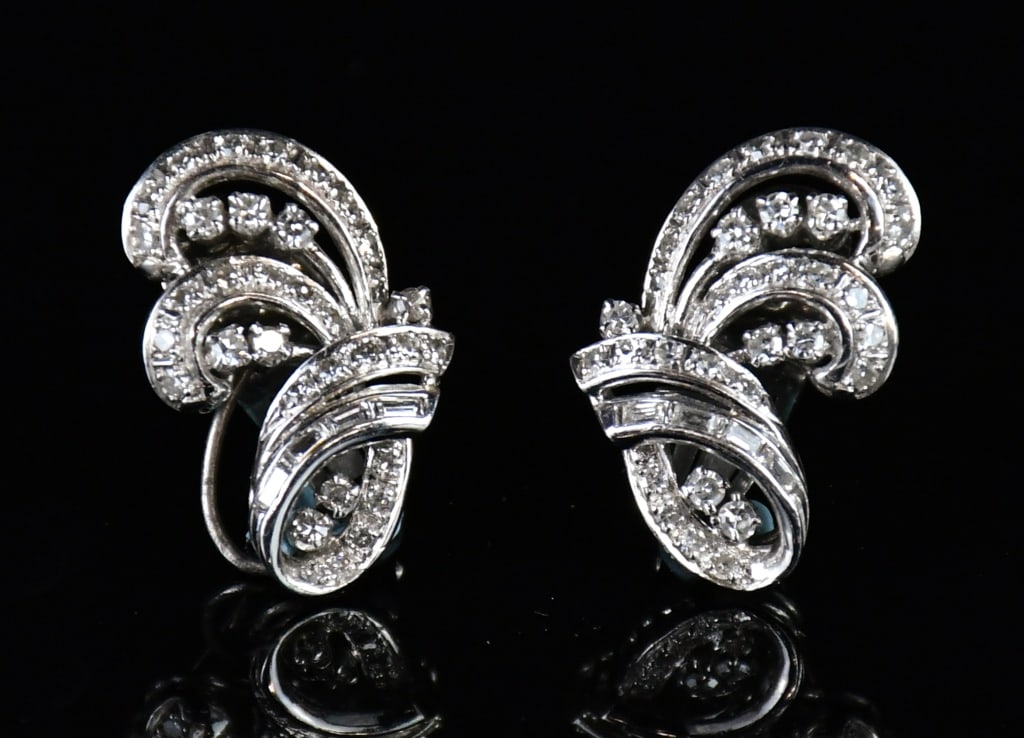 Pair Of Diamond Platinum Casted Clip Earrings: One pair of tested platinum casted postless clip on backs earrings contains 16 single cut prong set natural diamonds, 50 single cut bead set natural diamonds, 8 baguette cut channel set natural diamon