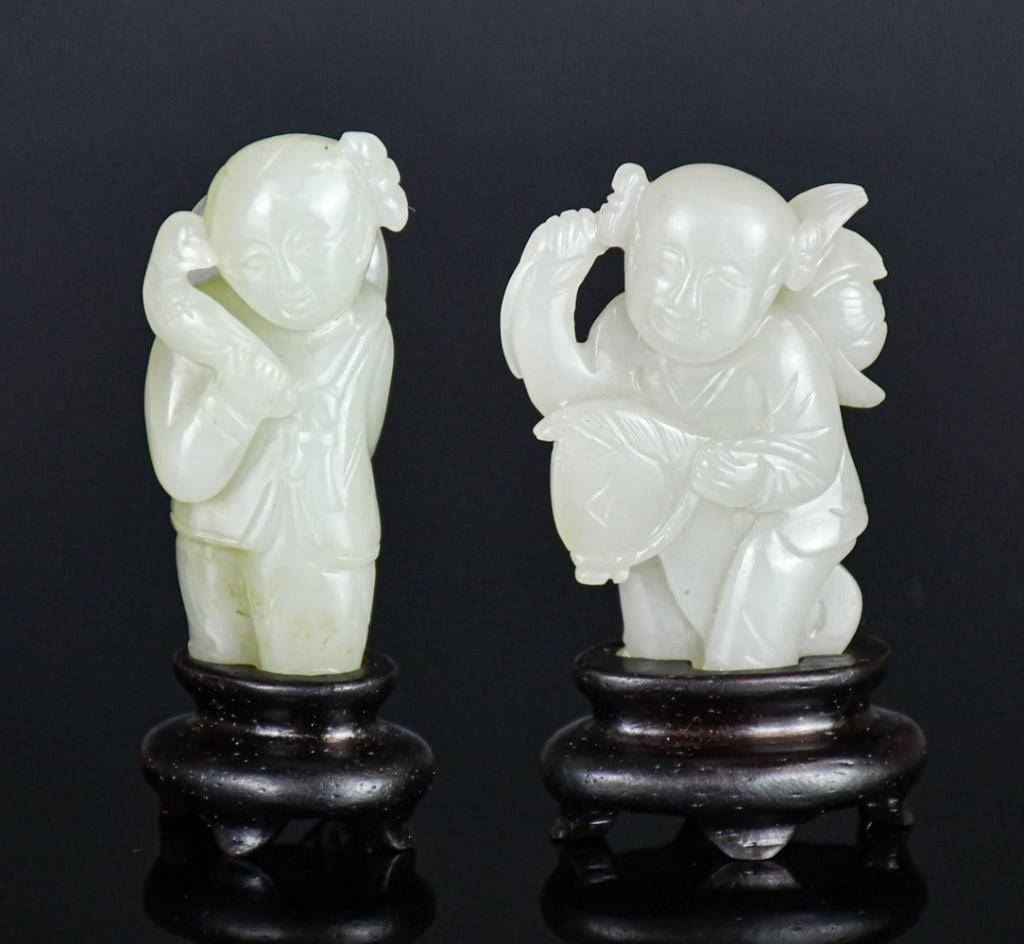 2Pcs Pale Celadon Jade Carvings w/Stds Qing: Comprising two jade carved figures, in various sizes and shapes, the stones overall in pale celadon color tone, H:4.7cm/ 5.2cm. Each comes with a matching wood stand. 清 青白玉