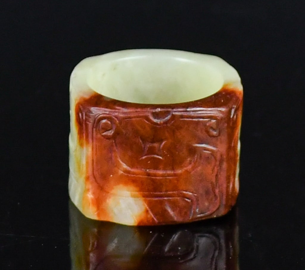 An Archaistic Incised Yellow Jade Cong: A small jade cong carved from yellow and russet jade, incised with archaistic pattern around the exterior, 2.7x2.7x2cm 高古風格刻紋黃玉琮 連