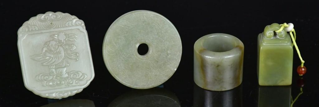 Group of 4Pcs Celadon Jade Carved Objects Qing: Comprising 2 pieces celadon jade plaques, a seal stone, and an Archer's ring, the largest size:5.4x4.4cm 清 各式青玉雕件一組4件
