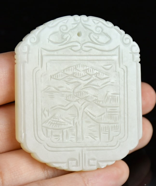 An Inscribed White Jade Landscape Plaque Qing: Of classic rectangular form with scalloped borders and a cusped arch head, the plaque worked in low relief on the primary face to depict landscape scene, while the other face with description, 4.5x5.5