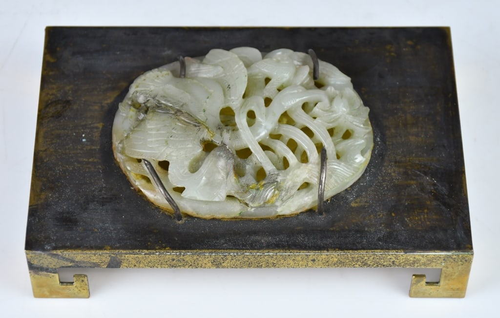 A Reticulated White Jade Oval Plaque On Panel Qing: This oval-shaped, openwork jade plaque is exquisitely carved using deep relief techniques, depicting a white egret perched amidst lush lotus leaves and pods. Its slender neck and wings are cleverly in