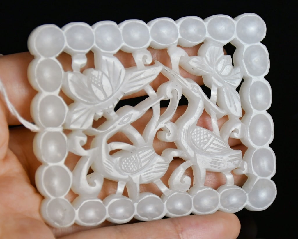 A White Jade Openwork Plaque Qing: The rectangular white jade plaque carved in openwork with cranes amidst scrolling floral branches, enclosed within border, the stone of white tone. 5.3x6.7cm 清 白玉透雕&