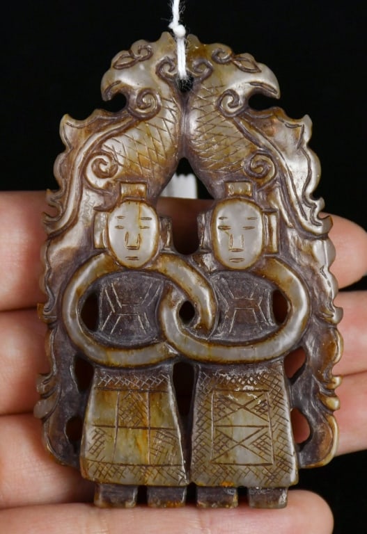 An Archaistic Jade Carved Double-Figure Pendant: Carved and pierced with two standing figures and two birds, the stone of mottled brown and russet tone. 7x4.6cm 高古風格 玉雕雙人物珮