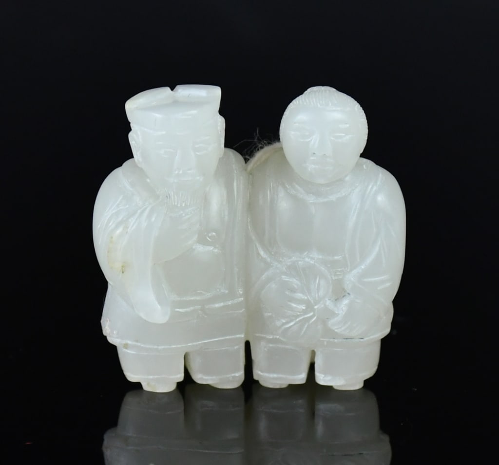 A White Jade Carved Double Figure Pendant: Carved with two figures, one stroking his beard, the other holding a palm-leaf fan, the stone of white tone. 3.3x3.3cm 白玉雕雙人物把件