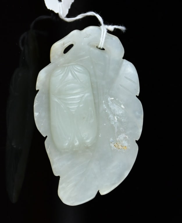 A Celadon Jade Carved Cicada On Leaf Qing: Carved as a leaf with a cicada resting atop, the stone of pale celadon tone. 6.5x3.9cm 清 青玉雕蟬伏葉擺件