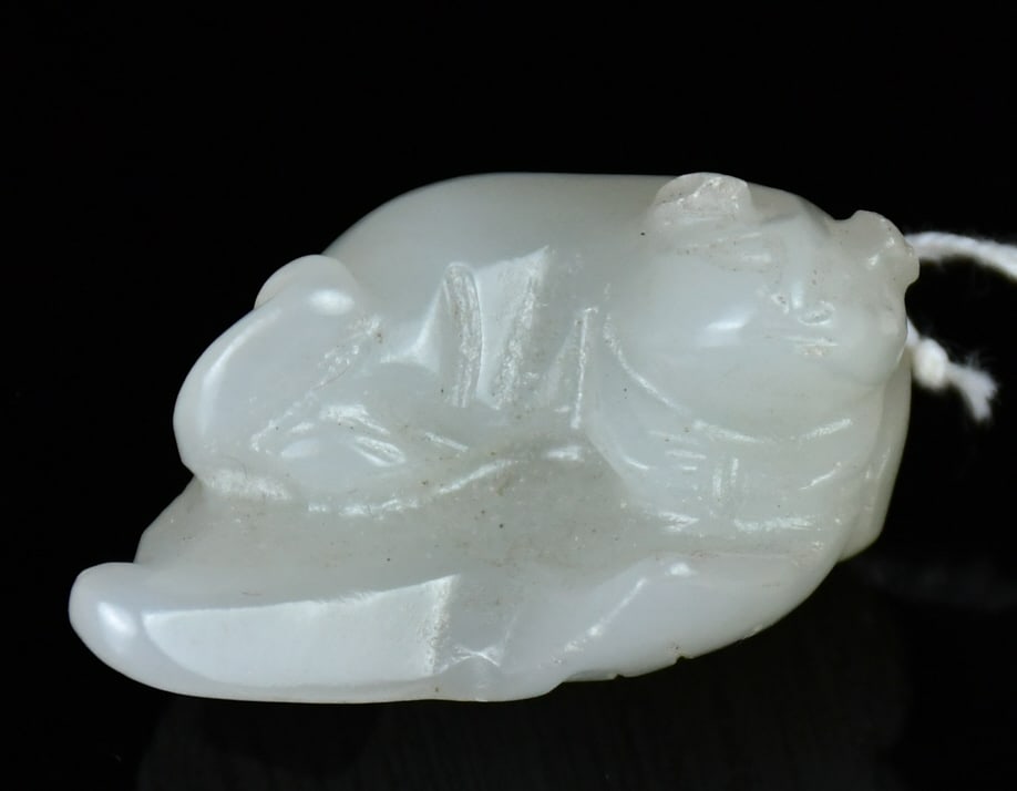 A White Jade Carved Beast on Leaf Qing: Carved as a mythical beast resting atop a leaf, the stone of white tone. 4.1x3.3cm 清 白玉雕葉上瑞獸把件
