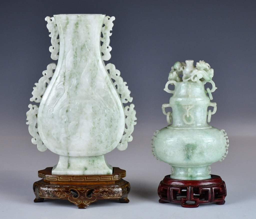Group of 2 Jadeite Vases w/Stds: Comprising a flattened vase carved in relief with scroll decoration, H: 17cm; and a pear-shaped vase with a globular body, loop handles suspending loose rings, the cover surmounted by openwork chilong