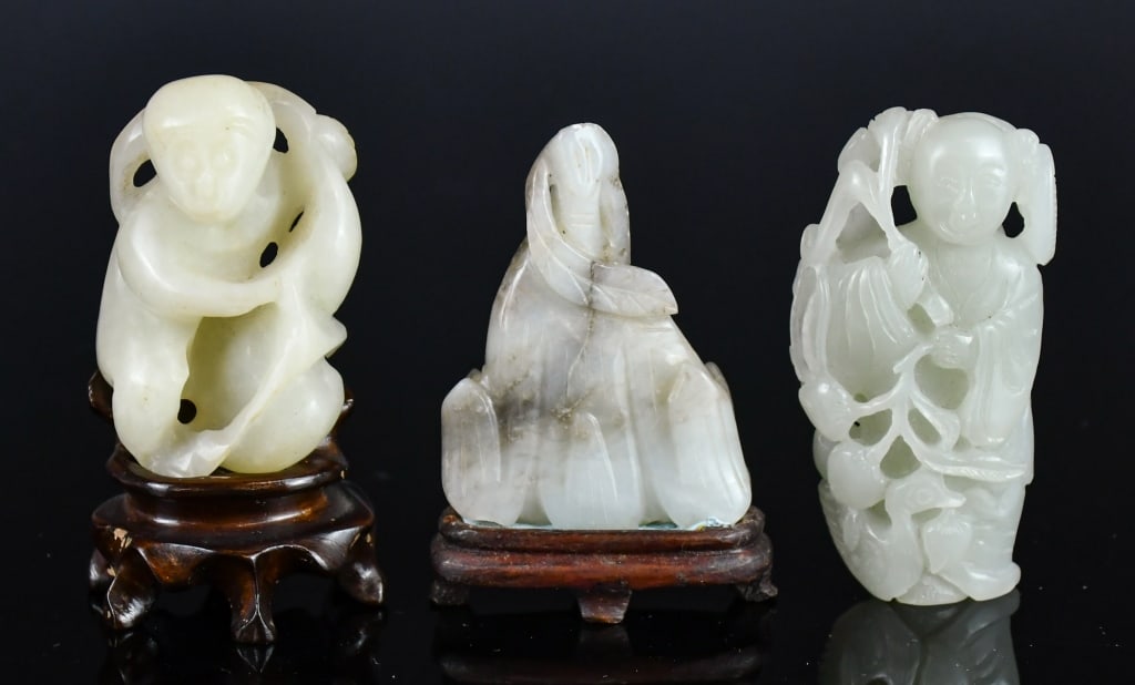 Group of 3 Jade Carved Ornaments w/2Stds: Comprising 3 pieces jade carvings in various shapes and styles, the stones overall in white color tone. The largest L: 6.5cm. Come with 2 matching wood stands 玉雕把件一&