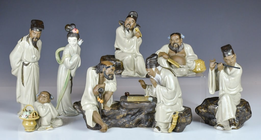 Liu ZeMian (1937-) S/7 Shiwan Figurines: Comprising seven figures of the Eight Immortals, each crafted in a distinct size and style, marked with the artist's seal on the inner base. Largest: H 24 cm. 劉澤棉 (1937-) 八