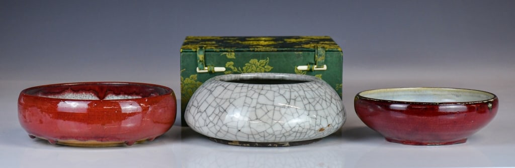 3 Shiwan Water Pots w/Box 20thC: Comprising two red-glazed brush washers of compressed form, together with a crackle-glazed washer of flattened globular form, each supported on a short foot. Largest D: 19cm 20世紀 石