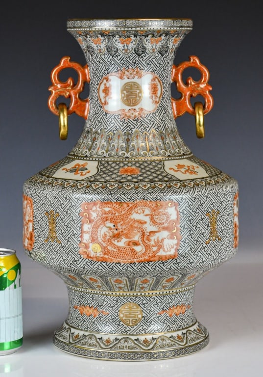 An Iron-Red Grisaille Vase Qianlong Mk 1950-70s: Potted with a high-shouldered ovoid body and a flared neck, flanked by a pair of dragon handles with loosing gilt rings. The exterior is densely decorated in iron-red and polychrome enamels with a com