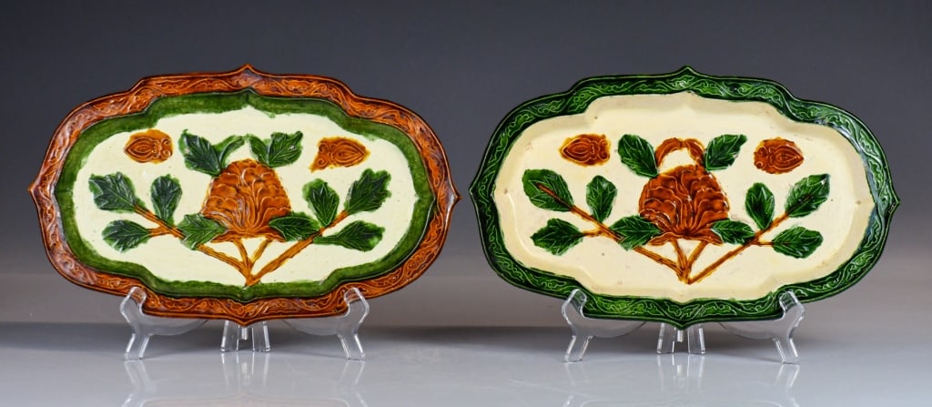 2 Ming-style Sancai-Glazed Molded Oblong Trays: The coloration of the rims is mirrored across the pair. Each tray is of elongated quadri-lobed form, featuring a slightly flared, stepped rim intricately molded with scrolling tendrils and ruyi-head s
