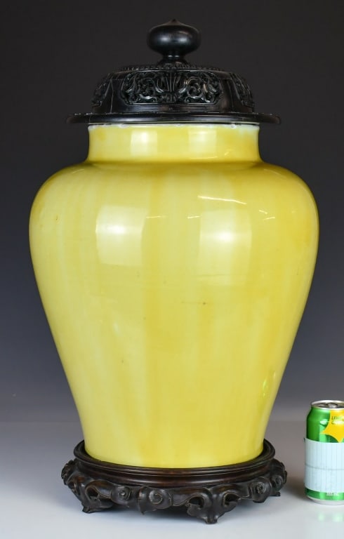 A Yellow-Glazed Covered Jar w/Std 17th-18thC: The yellow-glazed jar with short neck and rounded shoulders tapering to the base, comes with a wooden cover and stand. H: 41.5cm 17-18世紀 黃釉大蓋罐 連