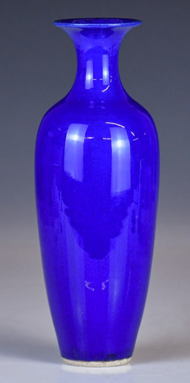 A Blue Glazed Vase Qing: Of baluster form, featuring a tall, tapering body that rises to a slender neck and terminates in a widely flared rim. Overall evenly covered with vibrant cobalt blue, H:23.5cm 清 藍釉