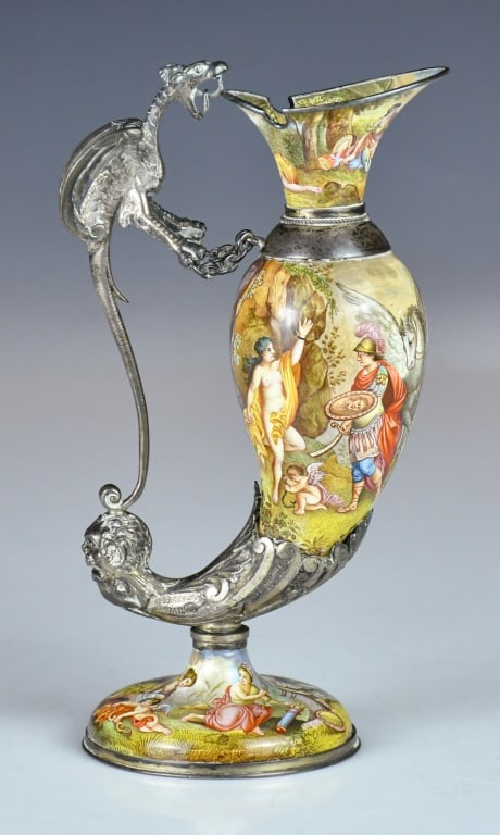 A Viennese Enamel Silver-Gilt Ewer 18thC: Of traditional Renaissance Revival form, the ovoid body, domed foot, and flared neck are exquisitely decorated with polychrome painted enamel vignettes. The ewer features a magnificent sculptural