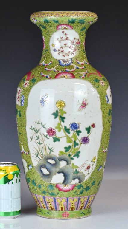 A Famille Rose Lime Ground Vase Xianfeng Mk: Of baluster form, the heavily enameled vase features large, finely detailed white-ground reserves depicting blossoming peonies, prunus branches, and fluttering butterflies, all against a vibrant