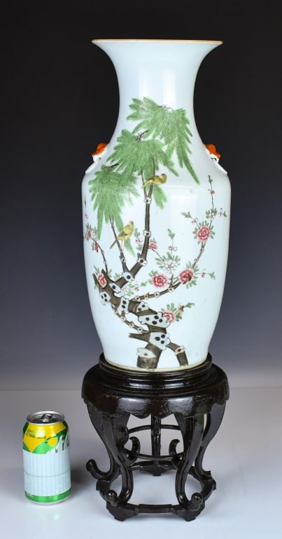 A Famille Rose Vase w/Std 19thC: With a flared rim, a tall waisted neck, and is applied with a pair of red beast-mask handles at the shoulders; the exterior is painted with birds perched amongst flowering branches. H:42.9cm 19世
