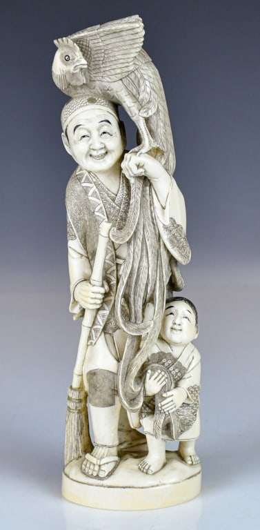 A Bone Carved Figurine: A bone carved statue of a male in standing position, with a phoenix on his shoulder and a child stands beside him, H:25cm 20世紀 骨雕人物立像
