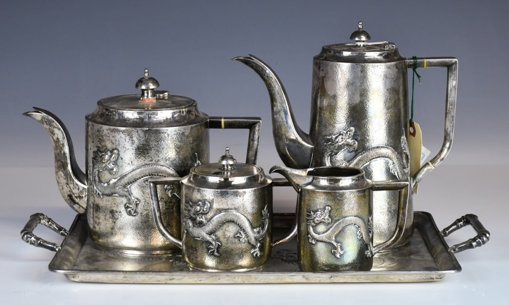 S/5Pcs Chinese Silver Dragon Teawares 19thC: Comprising a tray, a coffee pot, a tea pot a sugar jar and a creamer. All with dragon decoration around the exterior body. Each with maker's mark and '90' sign at the bottom. The coffee pot H:21.5cm, 